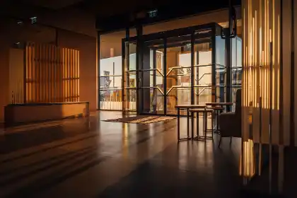 Modern glass entrance hall of an office building with incoming light, no people visible
